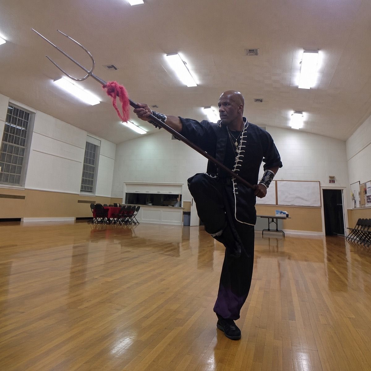 Sifu Mike Marshall in a one-leg stance with a trident